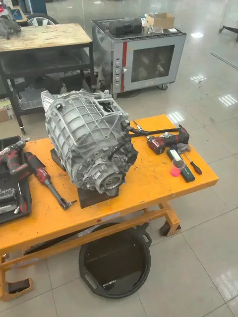 An electric drive unit on a workbench, ready for teardown.